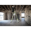 Човек на телескопична стълба от фибростъкло в строяща се сграда