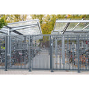 Автоматична врата Venus Locinox в зона за паркиране на велосипеди, с елегантен модерен дизайн.