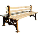 Дървена двойна пейка с чугунени крака, идеална за паркове и градски зони, осигуряваща удобно място за почивка.