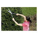 Жена използва ножици за храсти Fiskars PowerLever™ HS52 за подстригване на храст в градината.