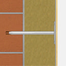 Метален дюбел за топлоизолация, показан в стена с изолация и тухлена повърхност.